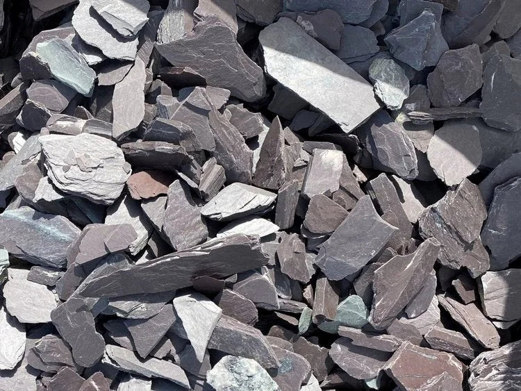 Plum slate chippings for gardens, in a pile with varying sizes and textures.
