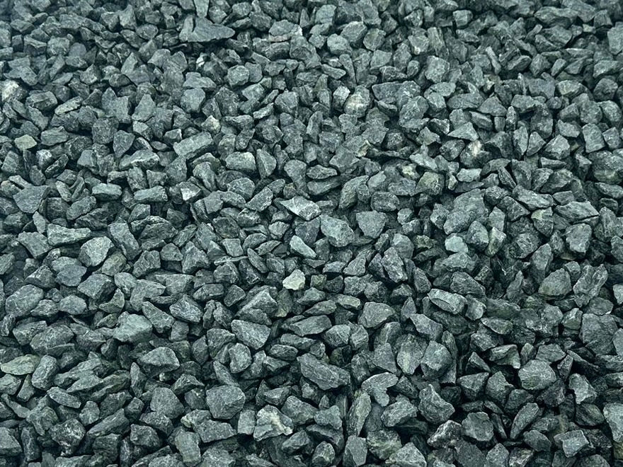 Green granite chippings for gardens from an overhead perspective, showing a rugged, textured surface.