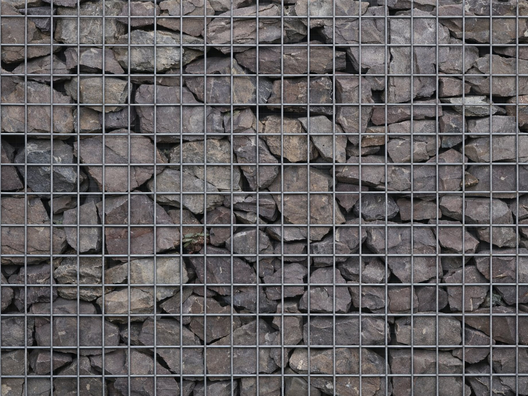 Plum slate gabion stones for gabion baskets, with grey hues and a rugged texture.