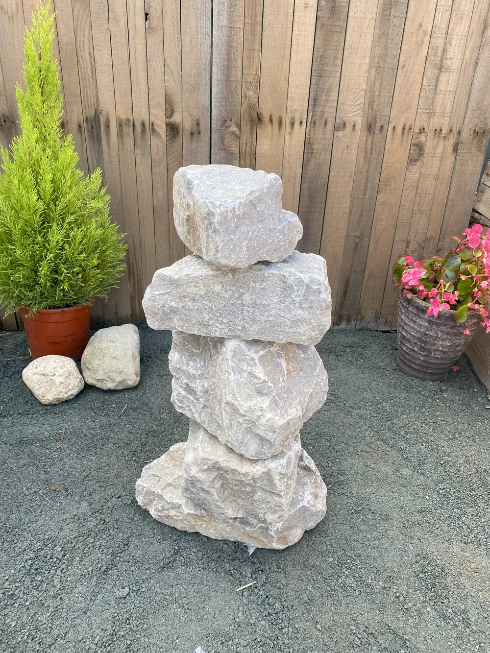 Small grey limestone pyramid stacked stones, 600mm, featuring a rough, natural texture.