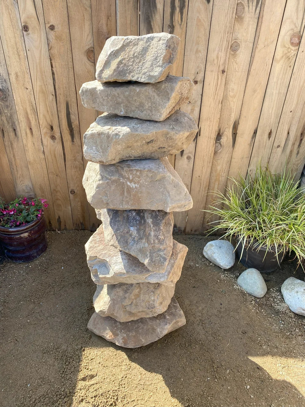 Large golden granite stacked stones, textured pyramid shape, with natural stone appearance.