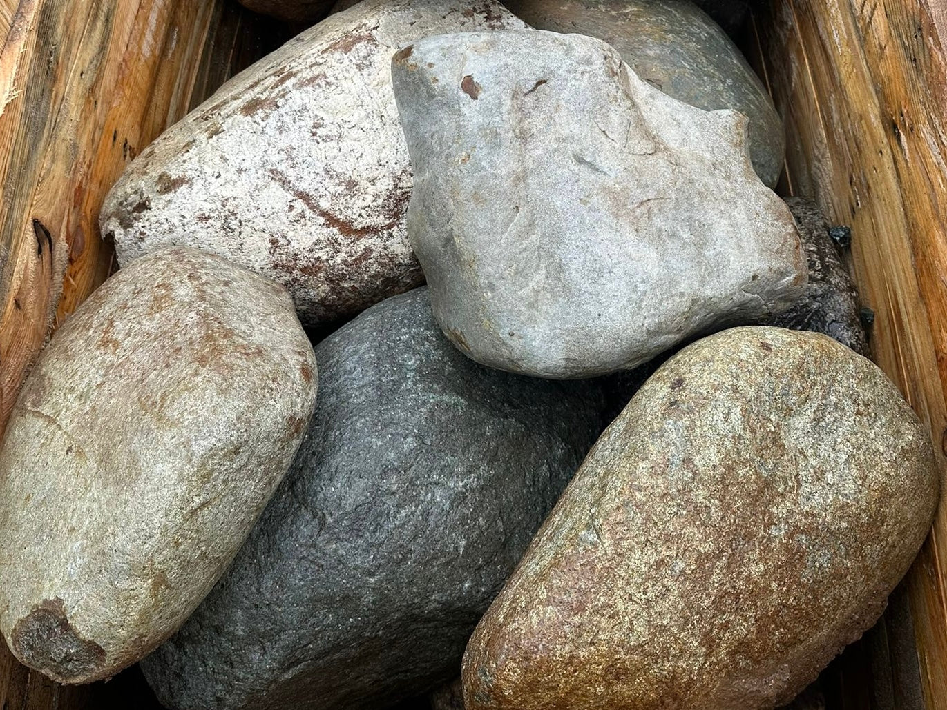 Pile of decorative garden boulders with textured surface.