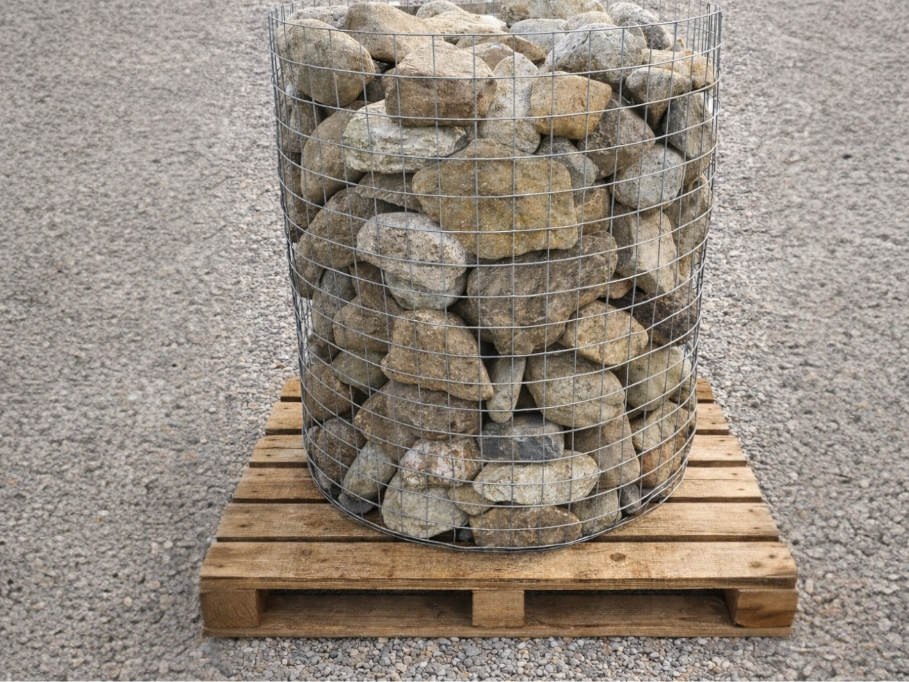 Small decorative garden boulders in a wire cage on a wooden pallet.