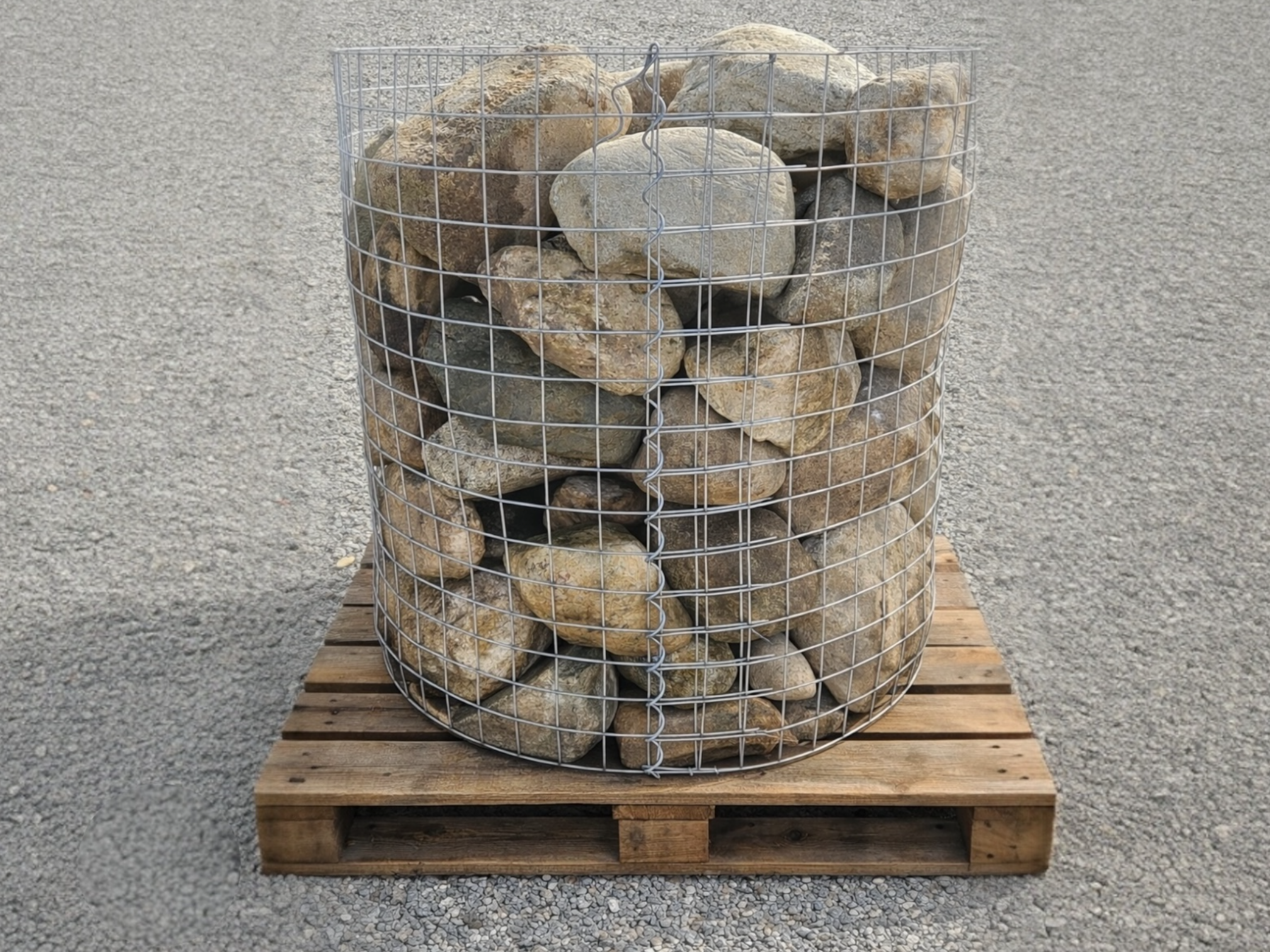 Large natural pond boulders from De Jonghe, contained in a wireframe crate on a wooden pallet.