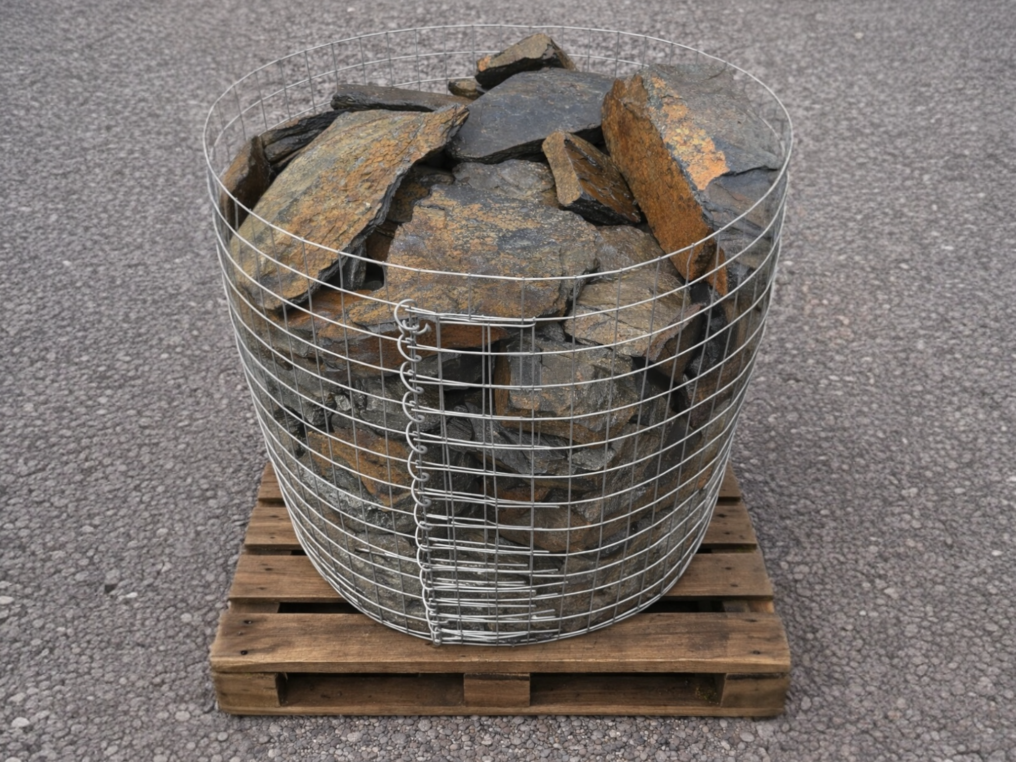 Rustic slate decorative pond stones on a wooden pallet.