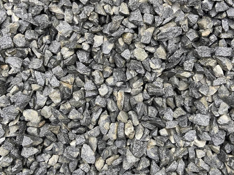 20mm black granite pond chippings with a rough, fragmented texture.