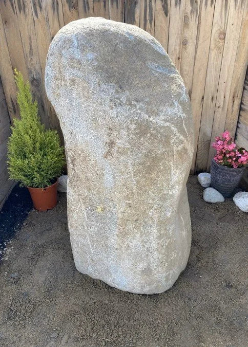 Boulder monolith standing stone by G04, with a rounded top and coarse, weathered texture.