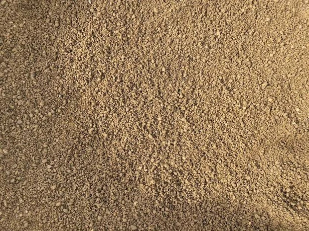 Golden self binding gravel for driveways with fine texture.