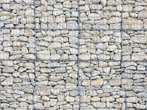 Light limestone gabion stones for gabion baskets with gray wire mesh pattern.