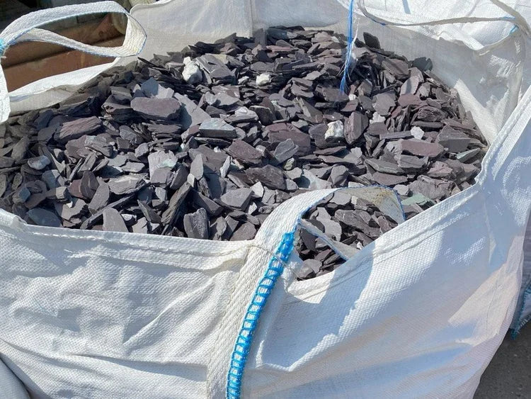 Plum slate chippings, 20mm, for gardens, inside a large white sack.