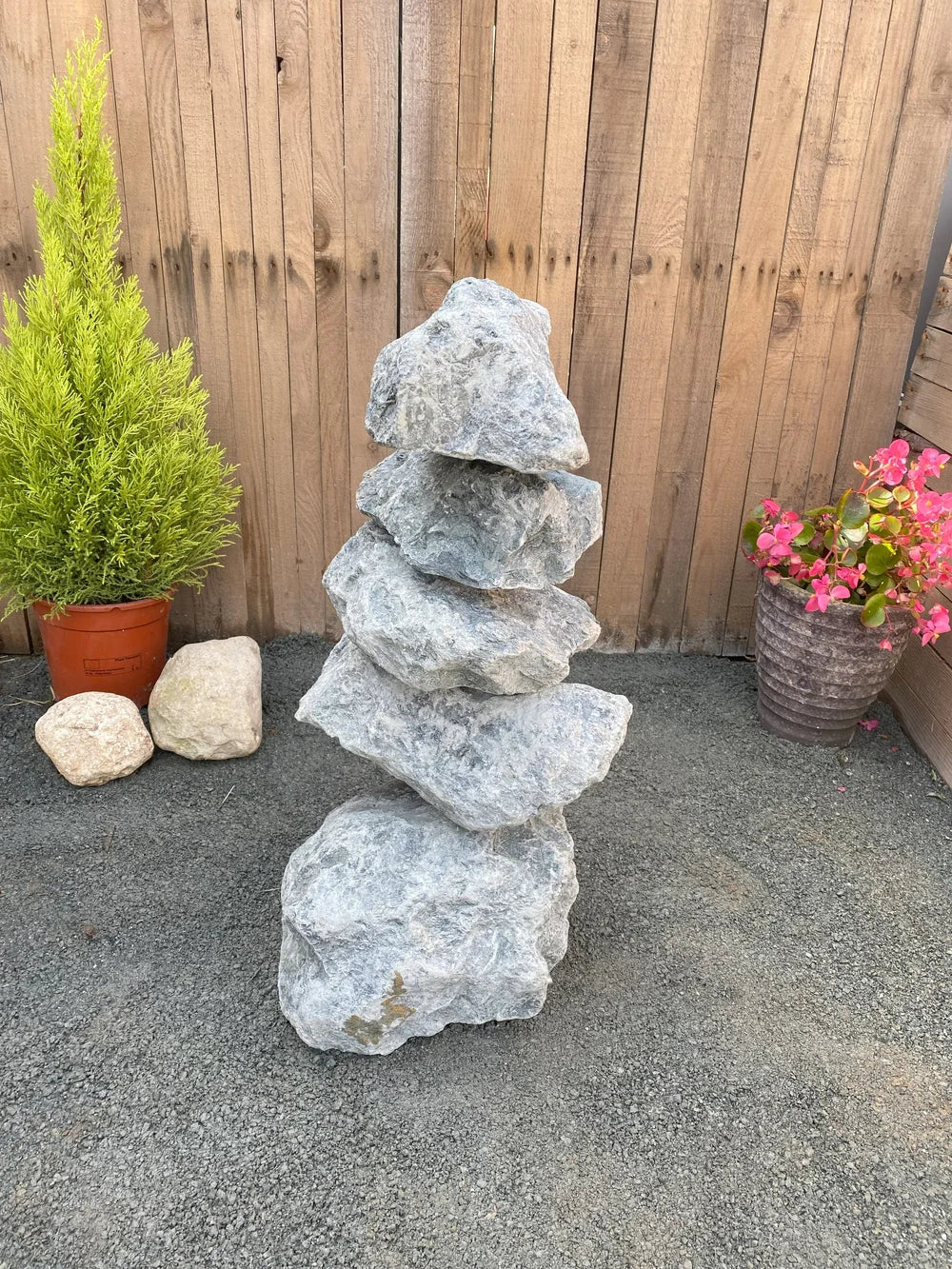 Green granite pyramid stacked stones (600mm) with a rough, textured surface, arranged on gravel.