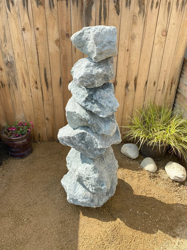 Large green granite pyramid stacked stones, 1000mm tall, with rugged texture, sitting on brown pebbles.