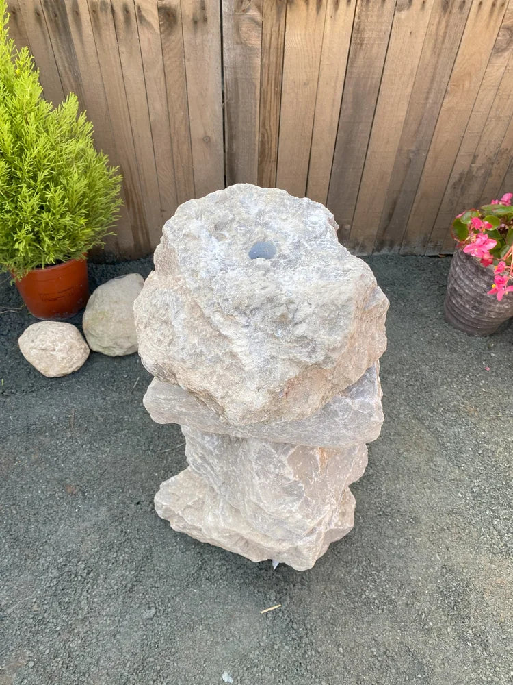 Small grey limestone water feature by WaterGems, stacked with rugged natural texture.