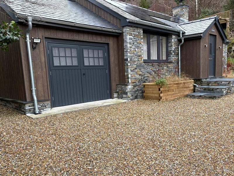 Golden granite chippings 20mm for gardens covering the ground.