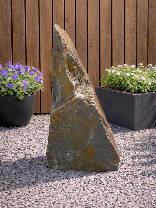 Slate monolith water feature, 1000mm, with layered texture, in an outdoor garden setting.