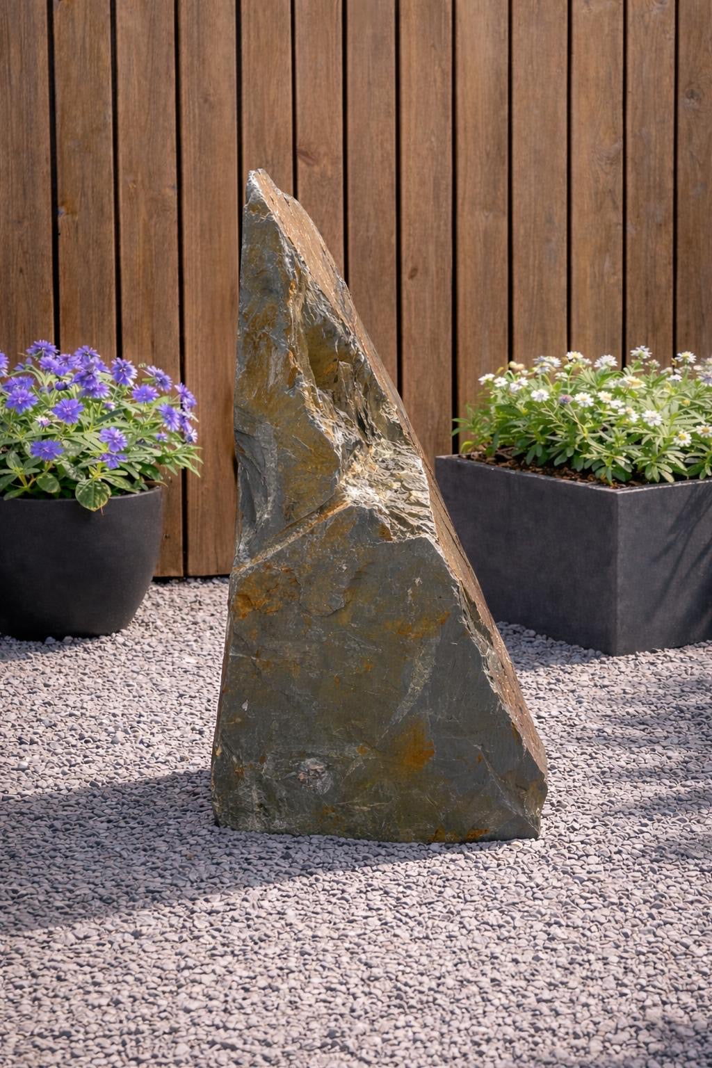 Slate monolith water feature, 1000mm, with layered texture, in an outdoor garden setting.