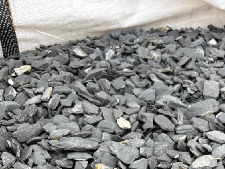 Grey slate chippings for pond edging with a 40mm size, in a pile.