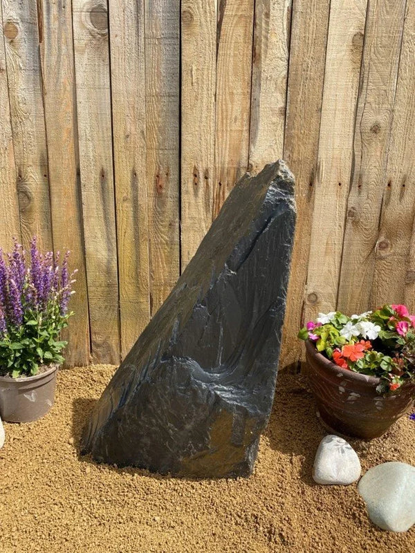 600mm slate monolith water feature by Water Feature C015, standing next to potted flowers and decorative stones.