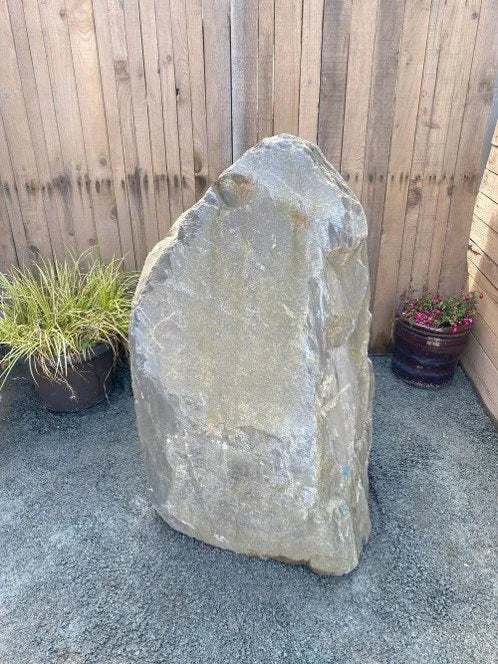Grey slate monolith feature stone by 029, standing vertically with rough, textured surface.