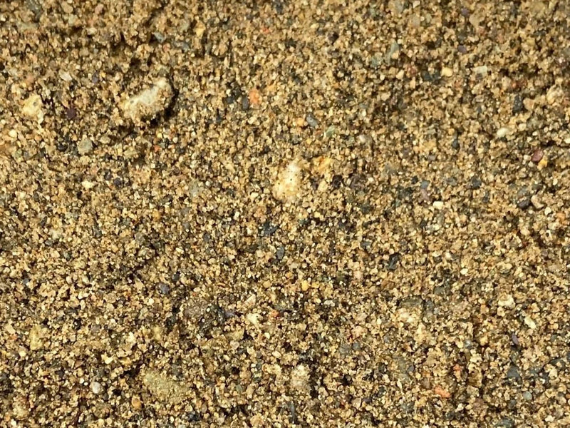 Horticultural coarse sand with a 0-4mm grain size, showing a mix of light and dark particles.
