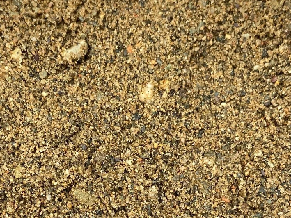 Horticultural coarse sand with a 0-4mm grain size, showing a mix of light and dark particles.