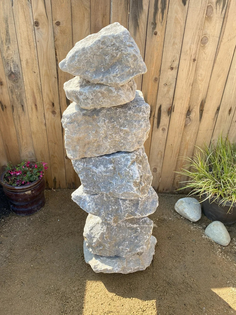Large grey limestone pyramid stacked stones, 1000mm, featuring a rough, natural texture.