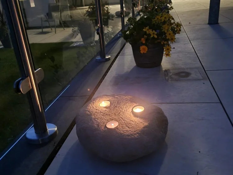 Three-hole decorative candle stone with candles, featuring a rough texture.
