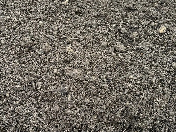 Dark, multi-purpose soil for horticulture, in a bulk bag, with a rough and earthy texture.
